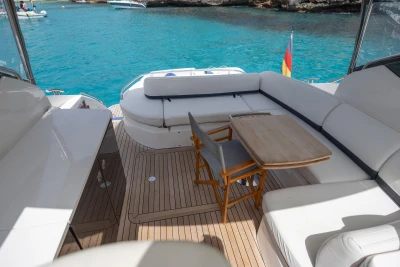 Luxurious 2015 Princess V39 yacht deck with seating, table, and scenic ocean view.
