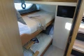 2016 Princess V58 Open yacht cabin with bunk beds and TV.