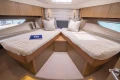 Luxurious cabin interior of 2016 Princess V58 Open yacht with twin beds.