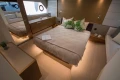 Luxurious bedroom interior of 2016 Princess V58 Open yacht with modern decor and ambient lighting.
