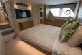 Luxurious bedroom interior of 2016 Princess V58 Open yacht with modern decor and large window.
