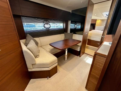 Luxurious interior of 2024 Princess V40 yacht with elegant seating and wooden finishes.