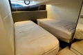 2024 Princess V40 yacht cabin with twin beds, modern design, and soft lighting.