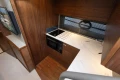 2024 Princess V40 yacht kitchen with modern wood cabinetry and sleek appliances.