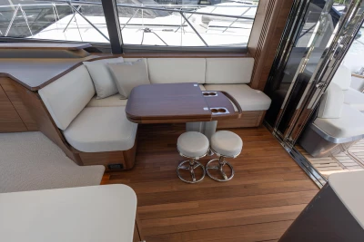 Luxurious interior of 2025 Princess S65 yacht with elegant seating and wooden flooring.