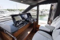 Luxurious 2025 Princess S65 yacht cockpit with modern controls and plush seating.