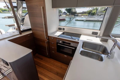 Modern kitchen interior on 2025 Princess S65 yacht, featuring sleek design and waterfront view.