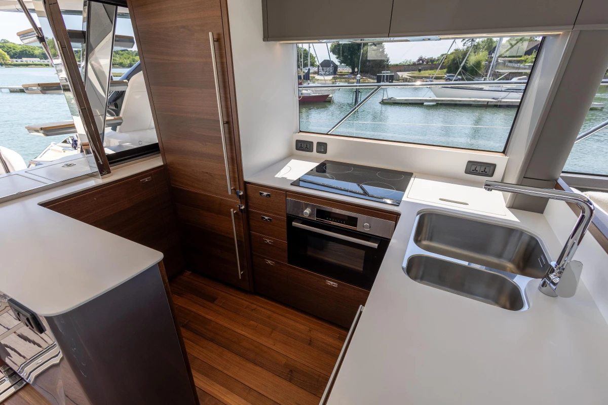 Modern kitchen interior on 2025 Princess S65 yacht, featuring sleek design and waterfront view.