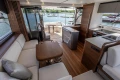 Luxurious interior of 2025 Princess S65 yacht with modern kitchen and seating area.