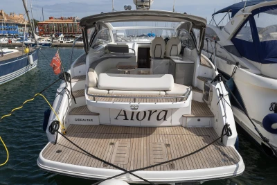 Luxury 2018 Princess V40 yacht docked in marina, featuring spacious deck and elegant design.