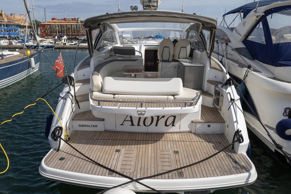 Luxury 2018 Princess V40 yacht docked in marina, featuring spacious deck and elegant design.