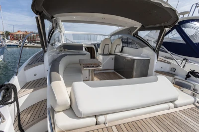 Luxurious 2018 Princess V40 yacht with elegant seating and sleek design in a marina setting.
