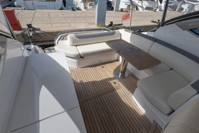 2018 Princess V40 yacht interior with elegant seating and wooden table.