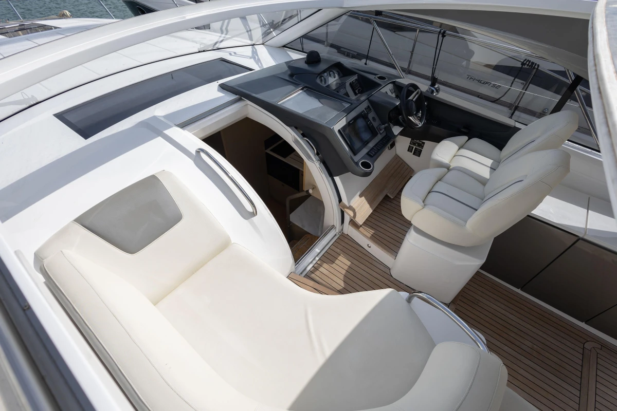 Luxurious interior of 2018 Princess V40 yacht with plush seating and modern dashboard.