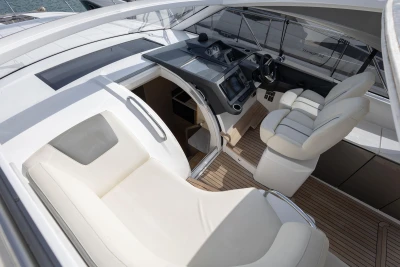 Luxurious interior of 2018 Princess V40 yacht with plush seating and modern dashboard.