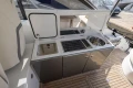 Outdoor kitchen on 2018 Princess V40 yacht with sink and grill on teak deck.