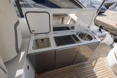 Outdoor kitchen on 2018 Princess V40 yacht with sink and grill on teak deck.