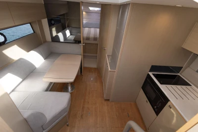 Interior of 2018 Princess V40 yacht with modern kitchen and cozy seating area.