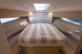 Luxurious interior cabin of 2018 Princess V40 yacht with cozy bed and modern design.