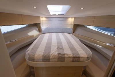 Luxurious interior cabin of 2018 Princess V40 yacht with cozy bed and modern design.