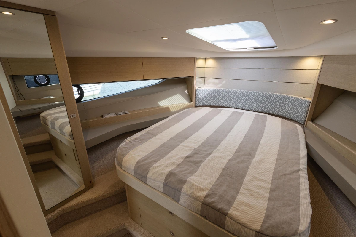 Luxurious interior cabin of 2018 Princess V40 yacht with striped bedding and modern design.