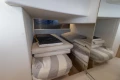 Cozy cabin interior of 2018 Princess V40 yacht with striped bedding and mirrored wall.