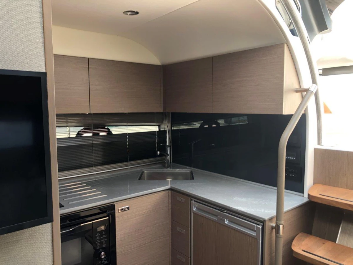 Modern kitchen interior in 2022 Princess V40 yacht, featuring sleek cabinetry and appliances.