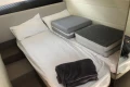 2022 Princess V40 yacht cabin with bed, cushions, and folded blanket.