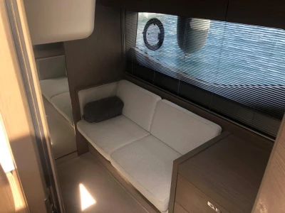 Modern interior of 2022 Princess V40 yacht with cozy seating and sleek design.
