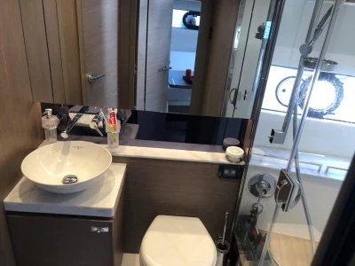 Modern bathroom in 2022 Princess V40 yacht with sink, toilet, and shower.