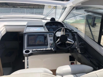 Helm of 2022 Princess V40 yacht with modern navigation equipment and steering wheel.