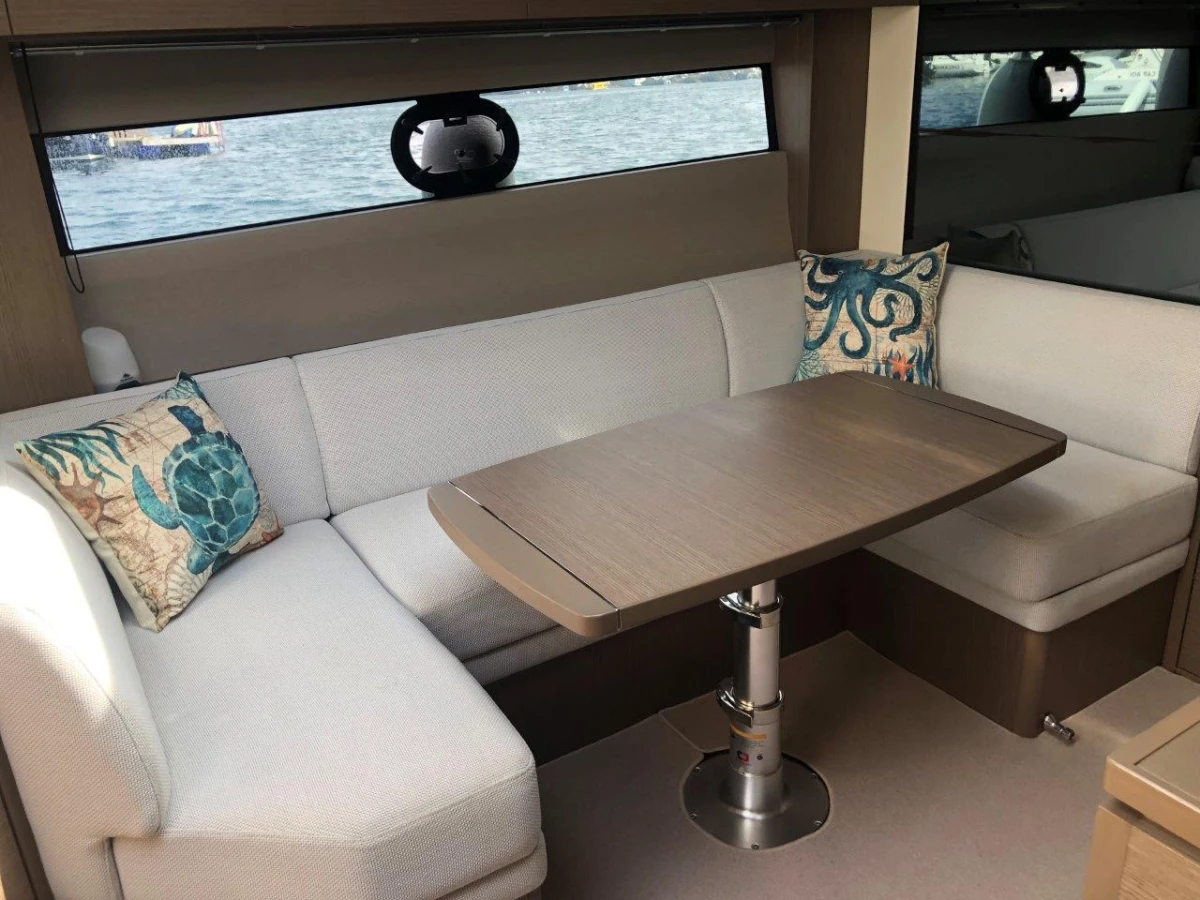 Luxurious 2022 Princess V40 yacht interior with elegant seating and decorative pillows.