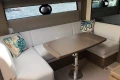 Luxurious 2022 Princess V40 yacht interior with elegant seating and decorative pillows.