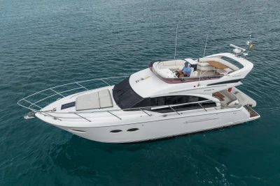Luxurious 2018 Princess 43 yacht cruising on clear blue waters.