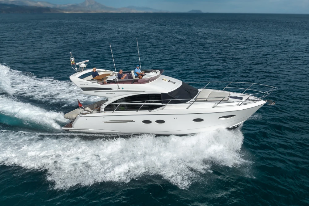 2018 Princess 43 yacht cruising on open sea with passengers onboard.