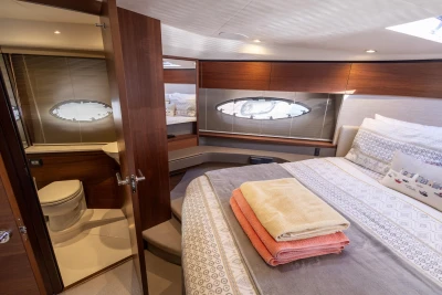 Luxurious cabin interior of 2018 Princess 43 yacht with bed and ensuite bathroom.