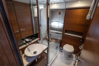 Luxurious bathroom in 2018 Princess 43 yacht with modern fixtures and wooden cabinetry.