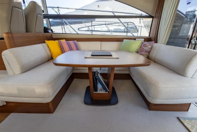 Luxurious interior of 2018 Princess 43 yacht with elegant seating and table.