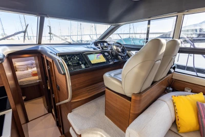 Luxurious interior of 2018 Princess 43 yacht with modern navigation system and comfortable seating.
