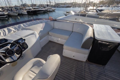 Luxurious 2018 Princess 43 yacht interior with seating and helm, docked in a marina.