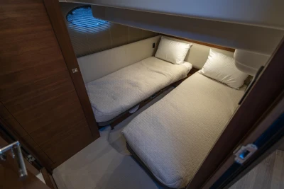Twin beds in a 2018 Princess 43 yacht cabin, featuring modern design and cozy ambiance.