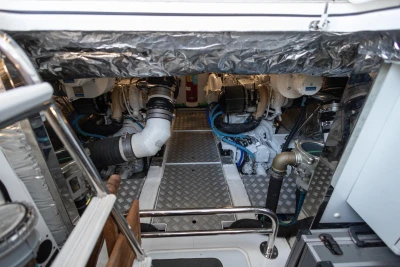 Engine room of a 2018 Princess 43 yacht, featuring dual engines and metallic flooring.
