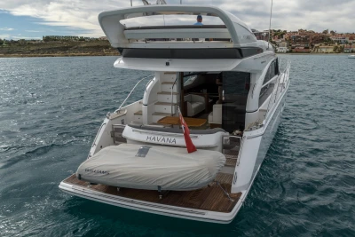Luxury Princess 43 yacht from 2018 on the water, featuring a small tender.