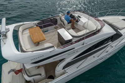 Luxury Princess 43 yacht from 2018 cruising on open water, featuring spacious deck seating.