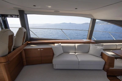 Luxurious interior of 2025 Princess F65 yacht with ocean view through large windows.