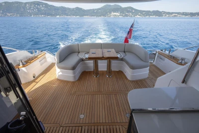 Luxurious 2025 Princess F65 yacht deck with seating, table, and ocean view.