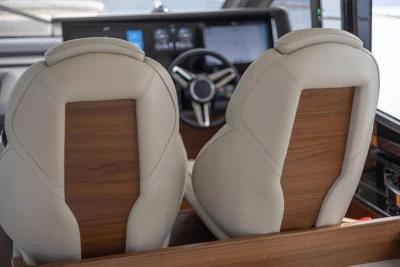 Luxurious leather seats in the 2025 Princess F65 yacht cockpit, featuring elegant wood accents.