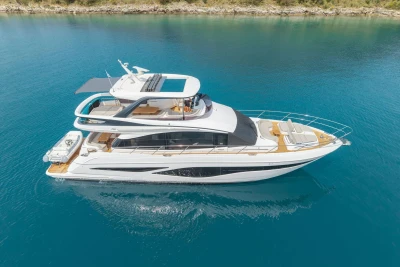 Luxurious 2025 Princess F65 yacht cruising on clear blue water.