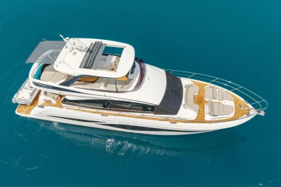 Luxurious 2025 Princess F65 yacht cruising on clear blue waters.