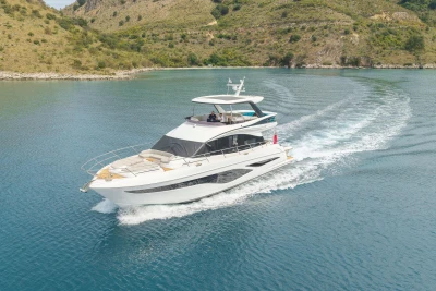 2025 Princess F65 yacht cruising in scenic coastal waters.